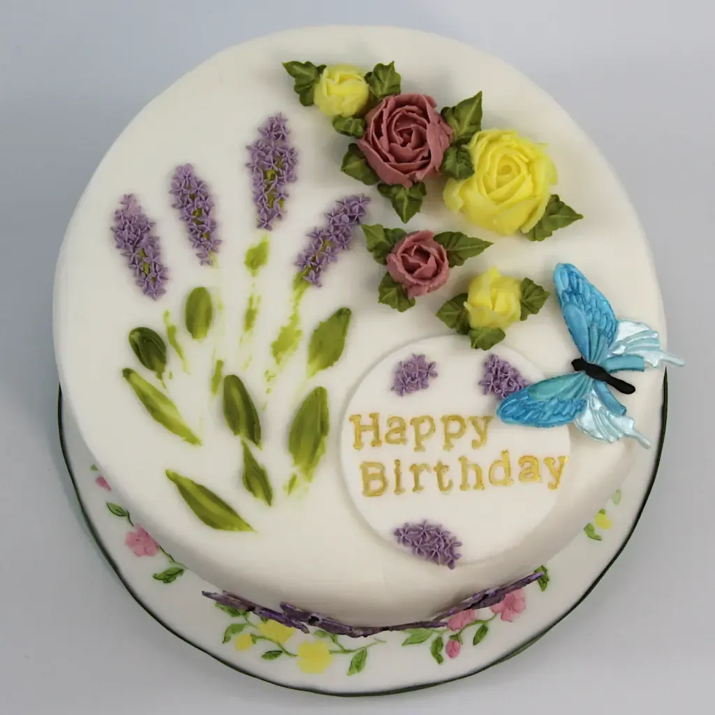 Birthday cake with lavender, flowers, and butterflies